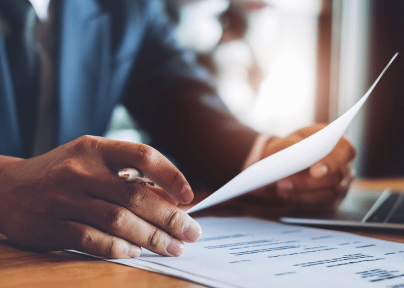 Person sitting at a desk looking at a resume