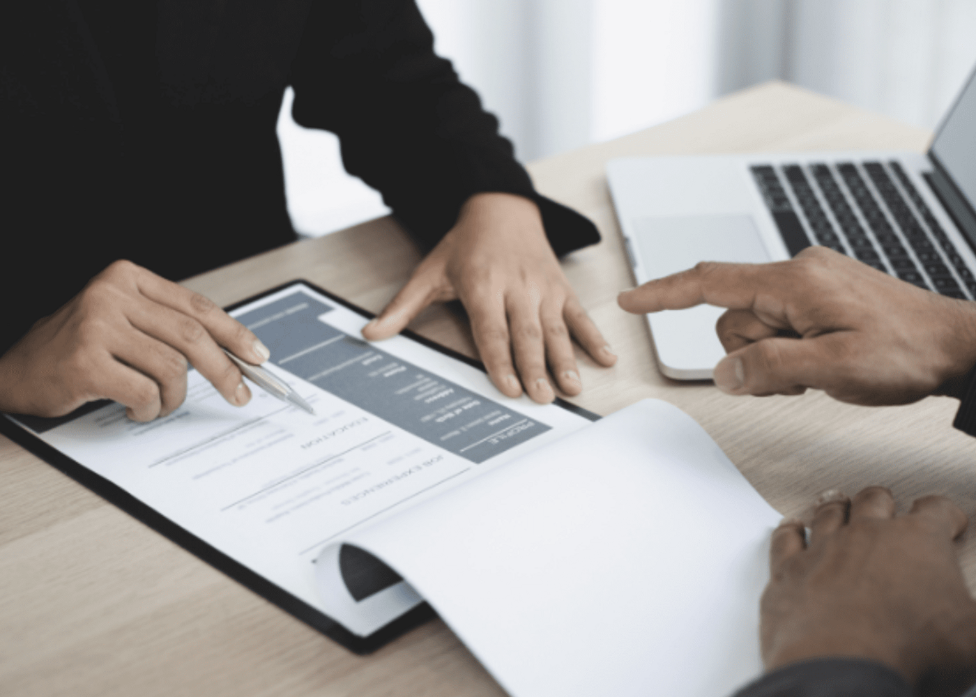 A business person reviewing a resume of the individual applying for a job