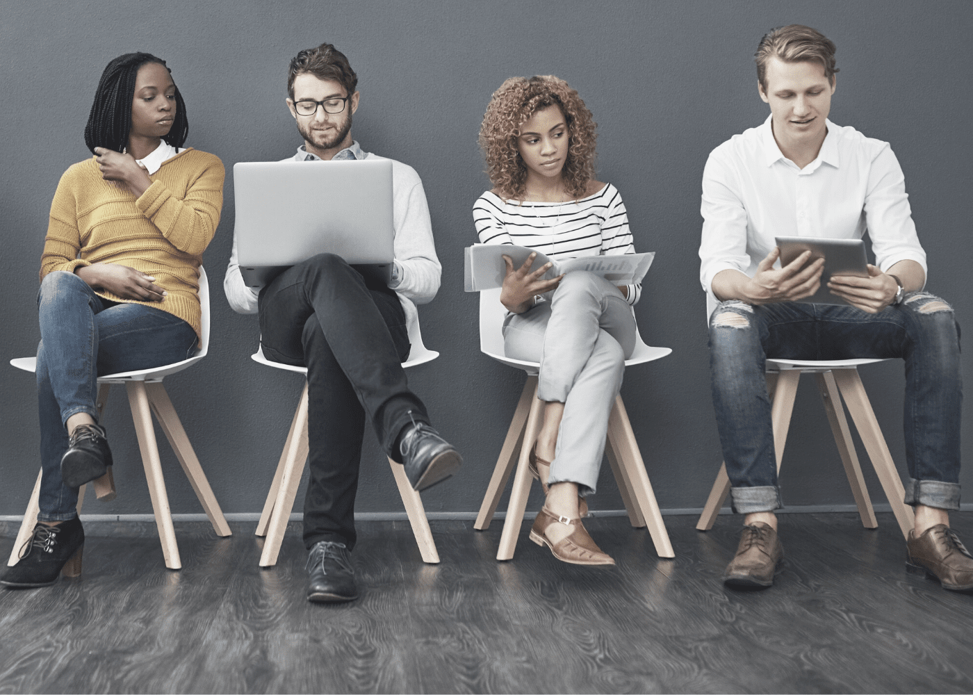 A diverse set of business professionals sitting in a row