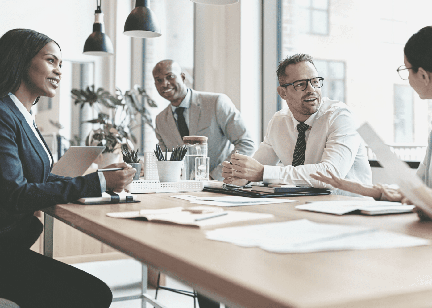 Group of business professionals sitting around a table discussing a presentation