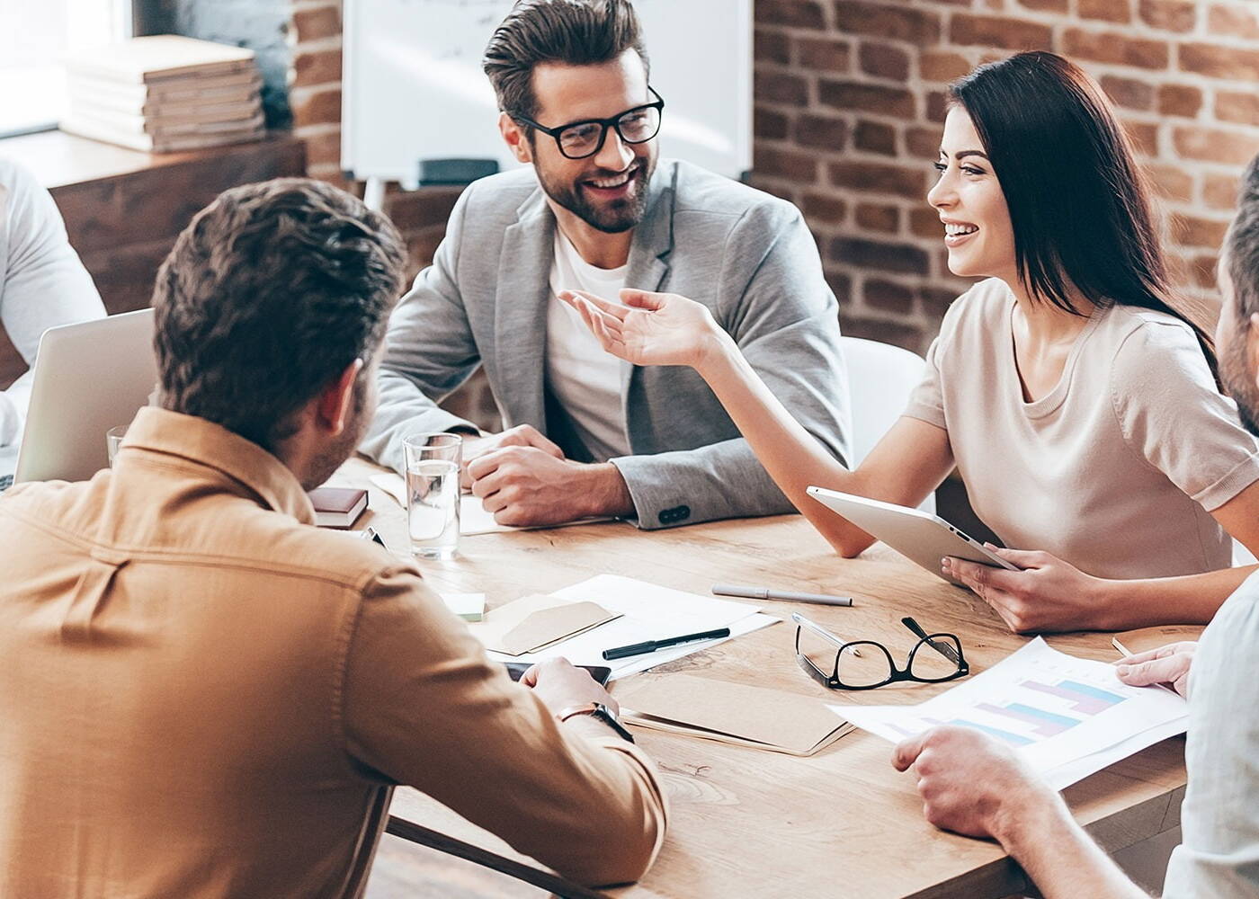 IT business professionals in a meeting with a well-dressed female presenting to colleagues 